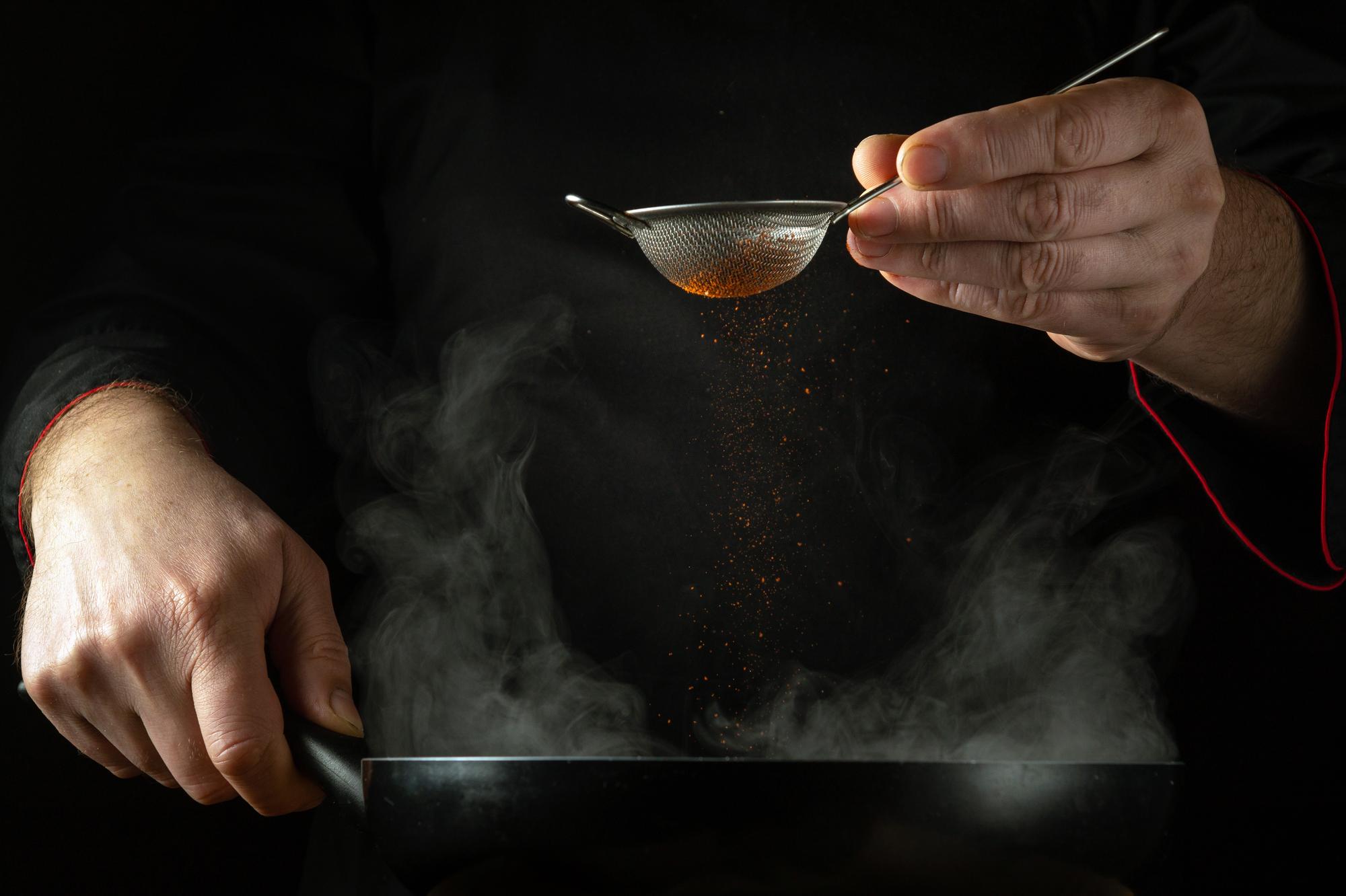 Chef using precision torch on sauce
